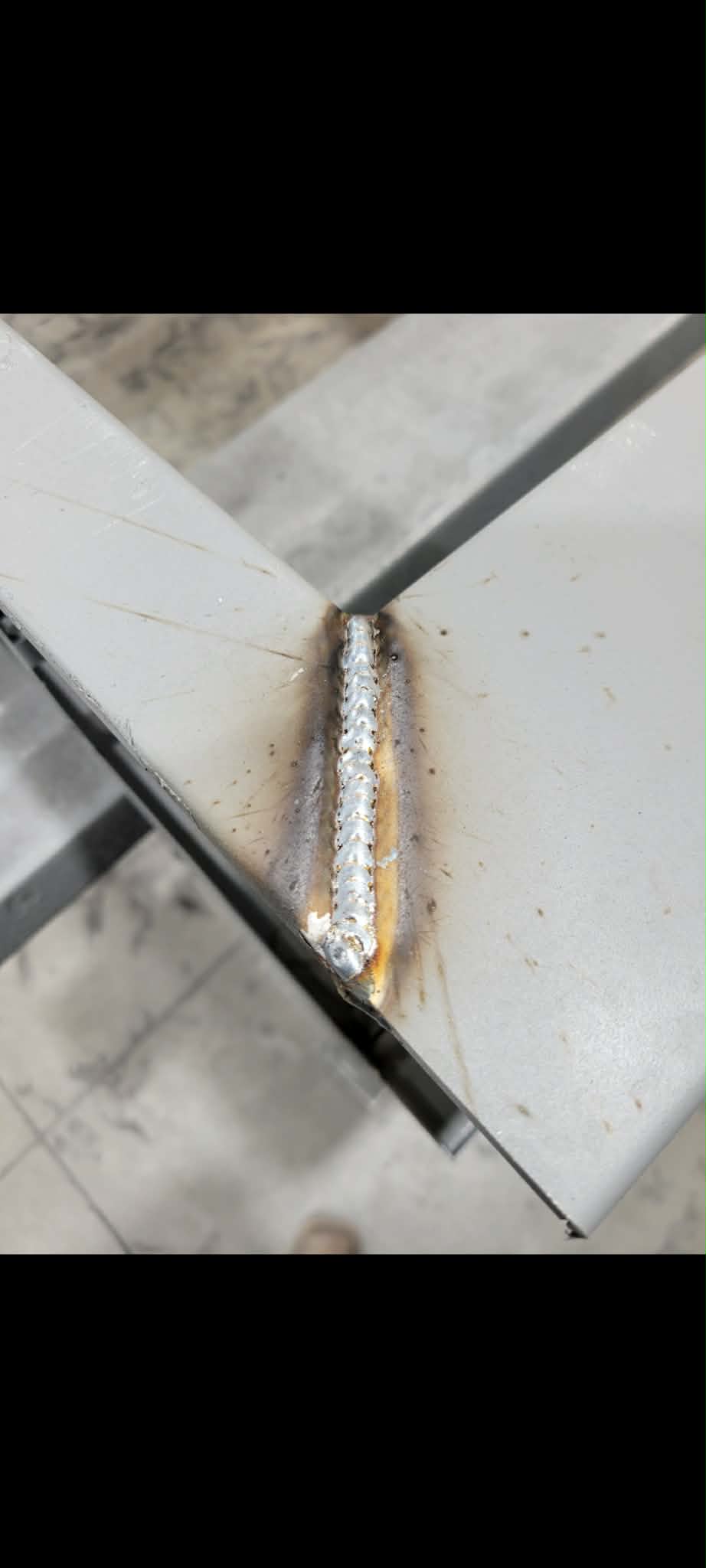 Precision weld bead on steel frame corner